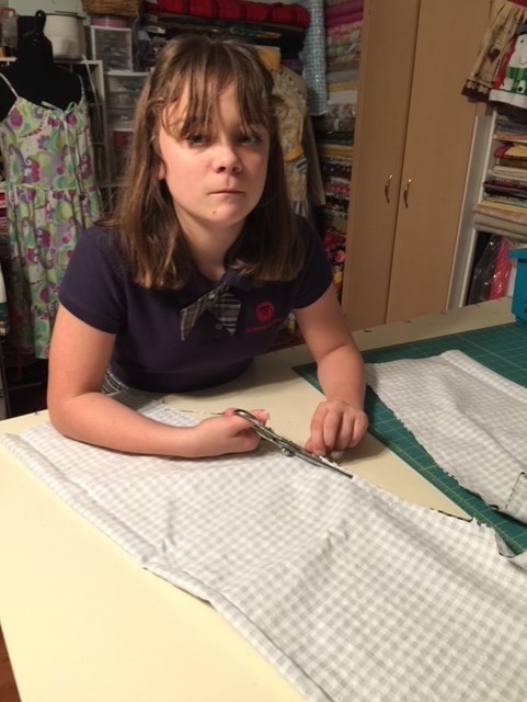 Little Girl Cutting the Fabric